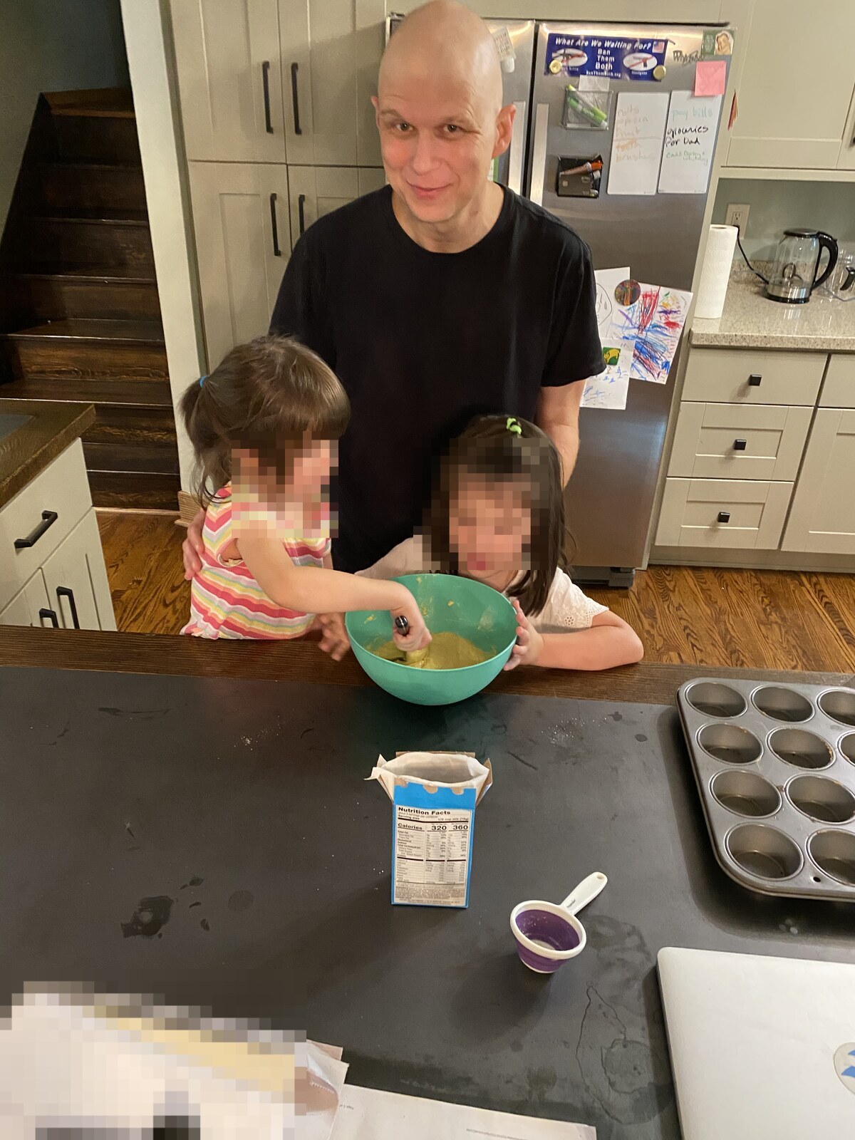 Clay Collins, bald from chemo, baking muffins with his daughters