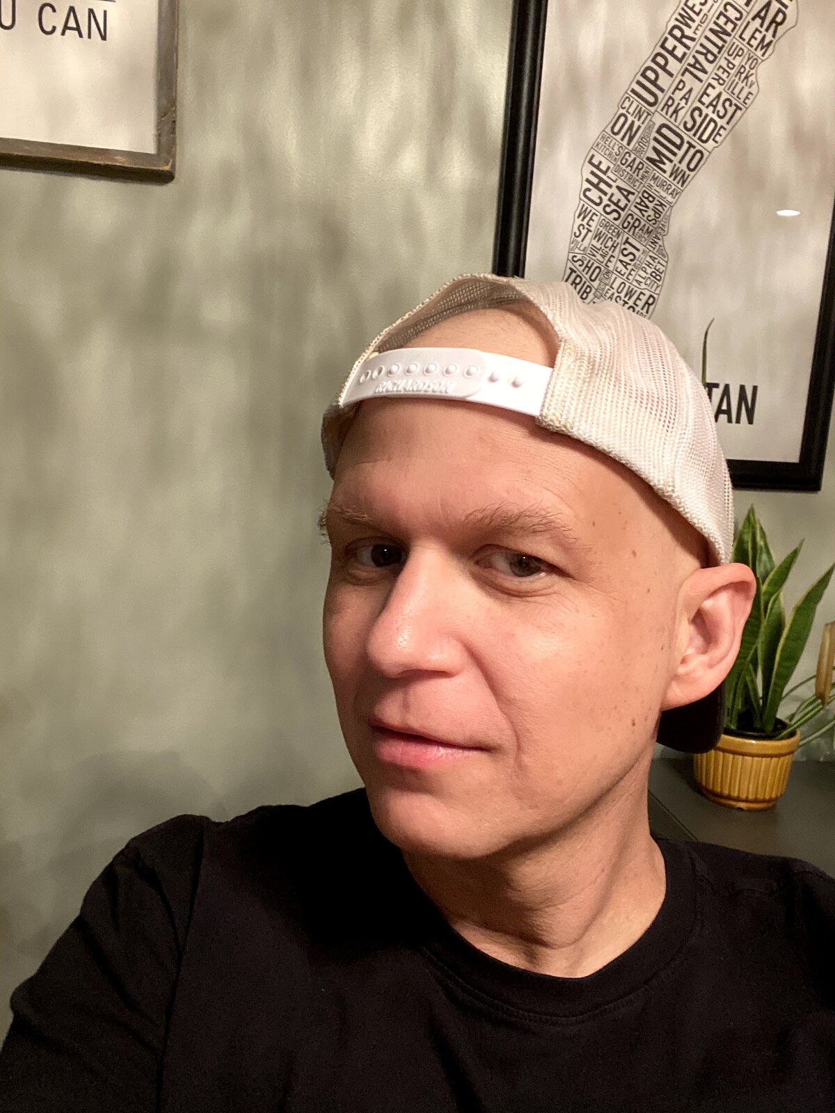 Clay Collins during chemotherapy, bald, wearing a backwards cap