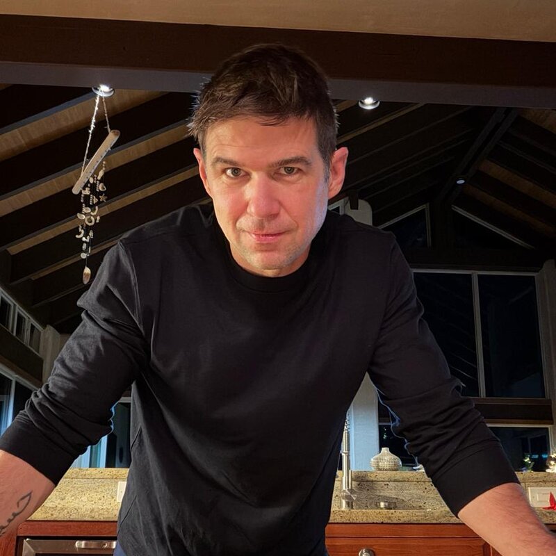 Clay Collins leaning on a kitchen island