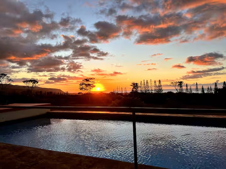 Sunset over the pool at Kualapa, with the Pacific in the distance